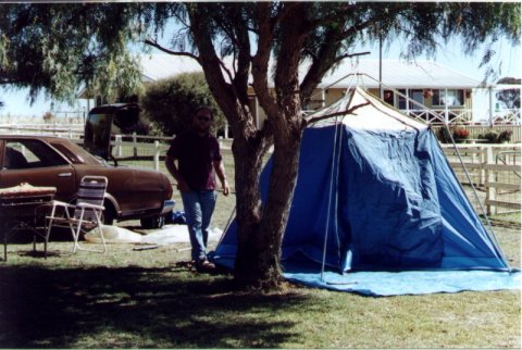 Publicity Officer standing next to his tent